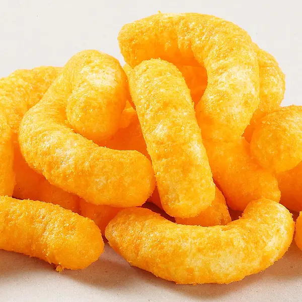 orange cheese puff snacks laying in a pile together